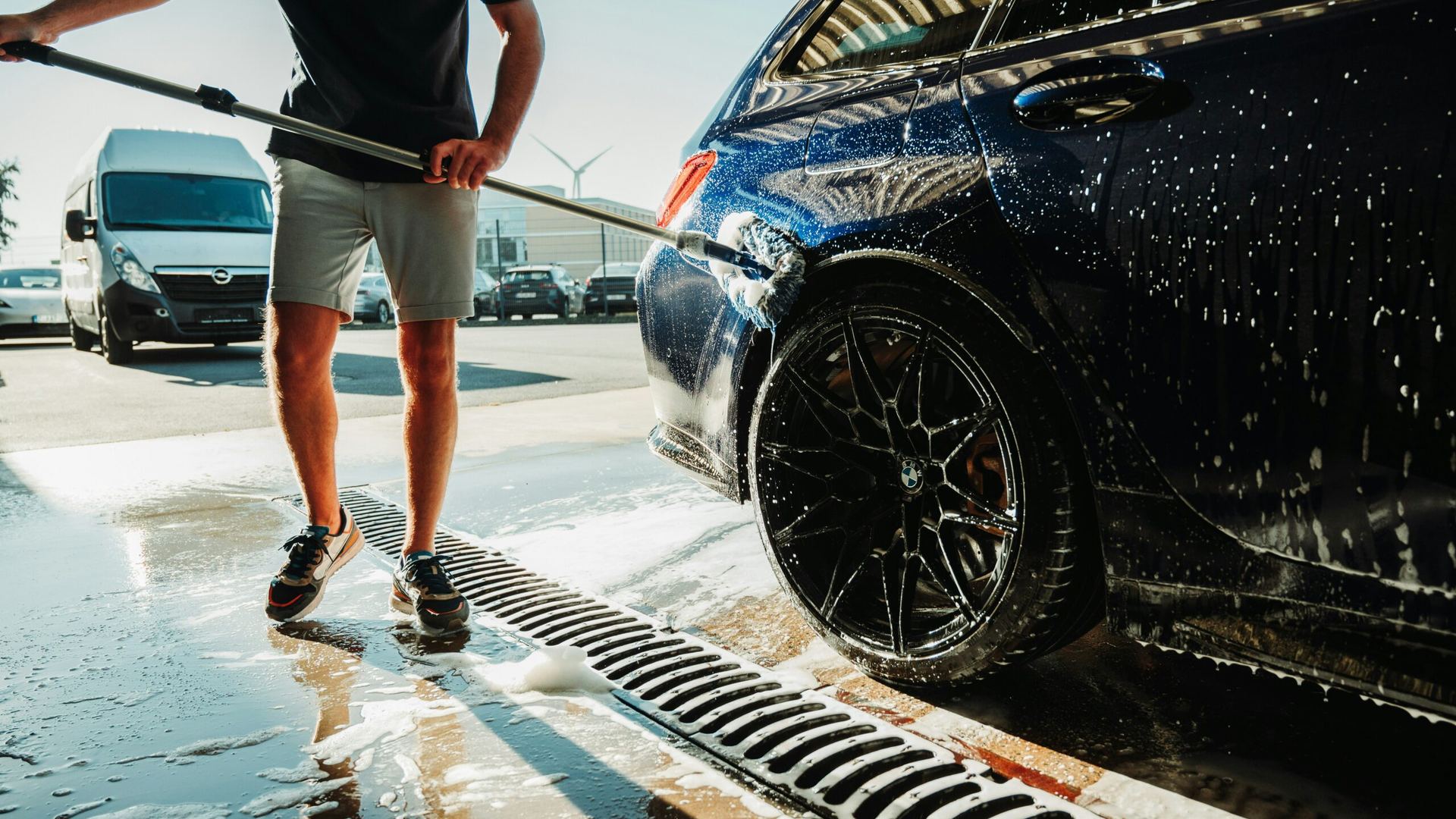 Washing a car with a pressure wand in a self-serve bay